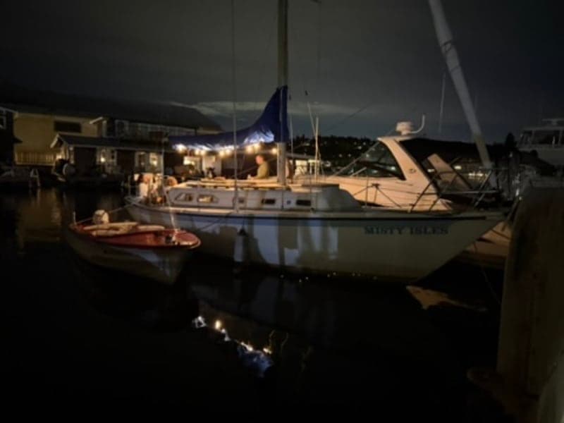 Boat at dock during evening with lights
